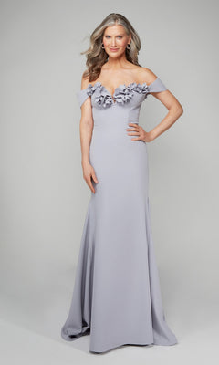 A woman wearing the Alyce 7062 long formal dress in Icelandic Blue, featuring an off-the-shoulder neckline and 3D floral bodice accents, stands against a plain background.