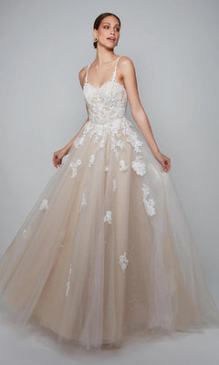 A woman poses in the Alyce 7084 Long White Dress in Ivory/Lt Latte, featuring a sleeveless fitted lace bodice with lace appliques and a full tulle skirt adorned with floral details.