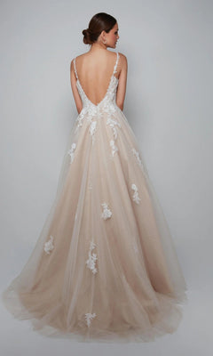 Woman wearing the Alyce 7084 long white dress, a sleeveless and backless bridal ball gown with a sweetheart neckline, lace appliqués, and a full tulle skirt, poses against a plain light background.