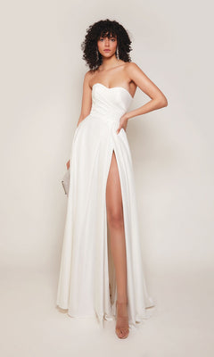 A woman in the Alyce 7088 long formal dress in diamond white, featuring a strapless design and high slit, holds a small clutch against a plain background.