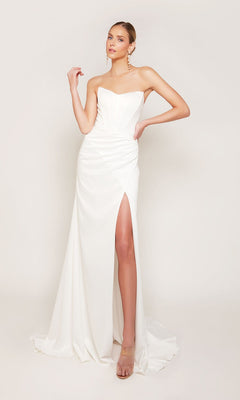 A woman confidently poses with one hand on her hip in the Alyce 7093 long formal dress—a strapless satin gown featuring a thigh-high slit, set against a plain background.