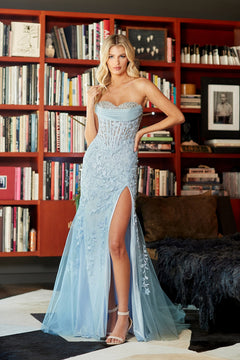 Amelia Couture 7096 is a strapless, pale blue floor-length gown with a beaded sweetheart neckline, lace applique corset bodice with floral embroidery, and a high thigh slit.