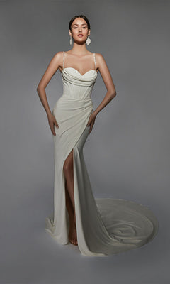 A woman models the Alyce 7103 long white dress, featuring a fitted stretch design with a sweetheart neckline, thin straps, corset bodice, and thigh-high slit. She stands against a plain gray background.