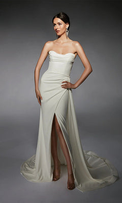 A woman models the Alyce 7105 long ivory dress, featuring a strapless sweetheart neckline and thigh-high slit, posed against a neutral background.