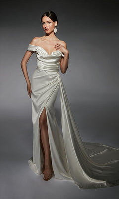 A woman stands against a gray background wearing the Long White Dress: Alyce 7106, featuring white satin fabric, a cowl neckline, off-the-shoulder sleeves, a thigh-high slit, and a long train.