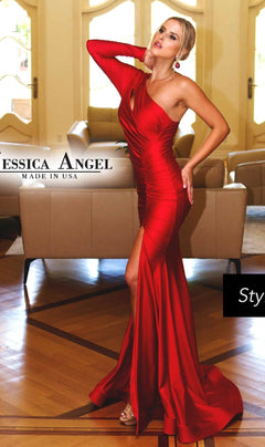 A woman poses indoors in the striking red One-Sleeve Long Prom Dress: Jessica Angel 711, featuring a fitted silhouette and thigh-high slit, standing out against beige sofas and large windows in the background.