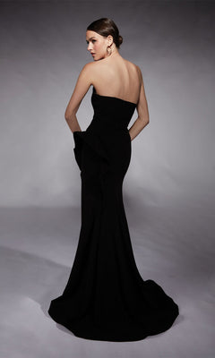 A woman models the Alyce 7113 long formal dress—a fitted, strapless black gown with a flared hem—posing against a plain studio background, ideal for special occasions.