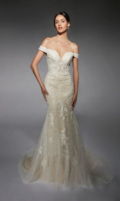 A woman wears the Alyce 7118 long white dress with an off-the-shoulder lace corset, sweetheart neckline, and long train, standing against a dark background.