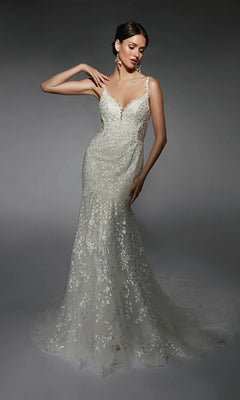 A woman poses against a plain gray background in the Alyce 7120 long ivory dress—a fitted floral lace bridal gown with thin straps, a scoop back, and a long, sheer train.
