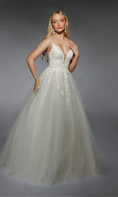 A woman in the Alyce 7127 long ivory dress, featuring a fitted floral-embroidered bodice and a full tulle skirt, stands against a gray background.