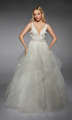 A woman wears the Alyce 7131 long white dress—sleeveless with a deep V-neck, 3D floral lace bodice, and layered ruffled tulle skirt—standing against a plain gray background.