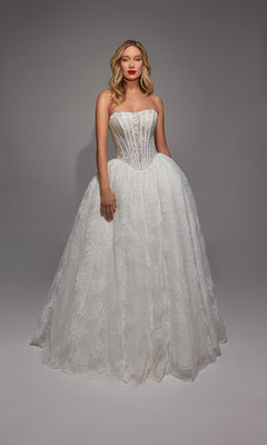 A woman poses against a plain gray background, wearing the Alyce 7149 Long White Dress featuring a strapless fitted bodice and a full lace skirt.