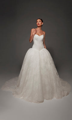 A woman poses against a dark background wearing the Long Wedding Dress: Alyce 7169, a strapless lace ball gown featuring a fitted bodice, full lace skirt, romantic sweetheart neckline, and a long train.