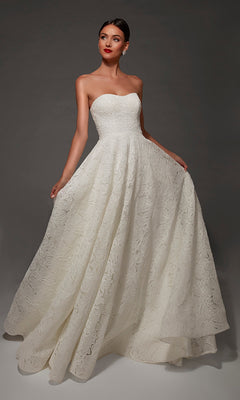 A woman poses against a dark background wearing the Alyce 7178 long wedding dress, featuring a strapless sweetheart neckline, a full skirt adorned with a textured floral pattern, and an elegant chapel train.