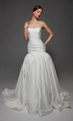 A woman wearing the Long Wedding Dress: Alyce 7181 in Diamond White poses against a plain, dark background.
