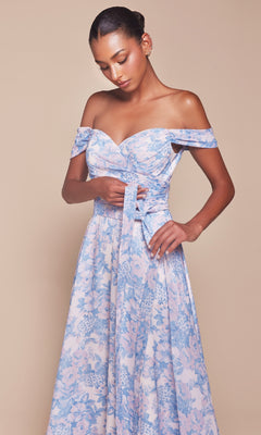 A woman stands against a beige background, tying the sash of the Ladivine 7441 Long Floral-Print A-Line Prom Dress in pastel blue and pink with an off-the-shoulder neckline.
