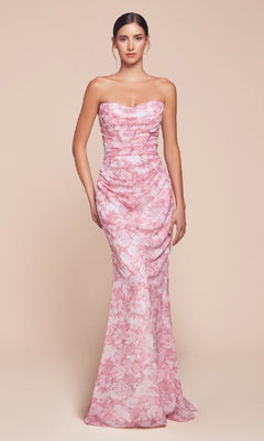 A woman stands facing forward in the Ladivine 7445, a strapless long floral-print prom dress in pink, set against a plain beige background.
