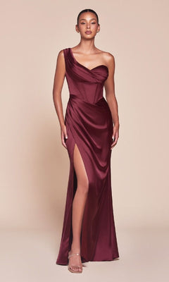 A woman in the Ladivine 7448 One-Shoulder Lace-Up Prom Dress, featuring a corset bodice and thigh-high slit, pairs it with strappy heels and poses against a plain beige background.
