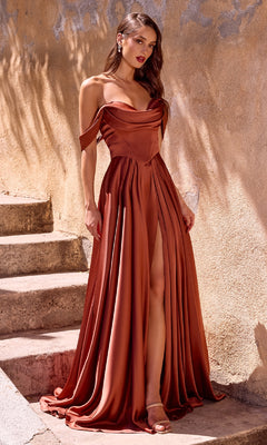 A woman stands on stone steps wearing the Lace-Up Long Satin Prom Dress: CL7449, an off-the-shoulder copper evening gown with a flowing silhouette and a dramatic thigh-high slit.