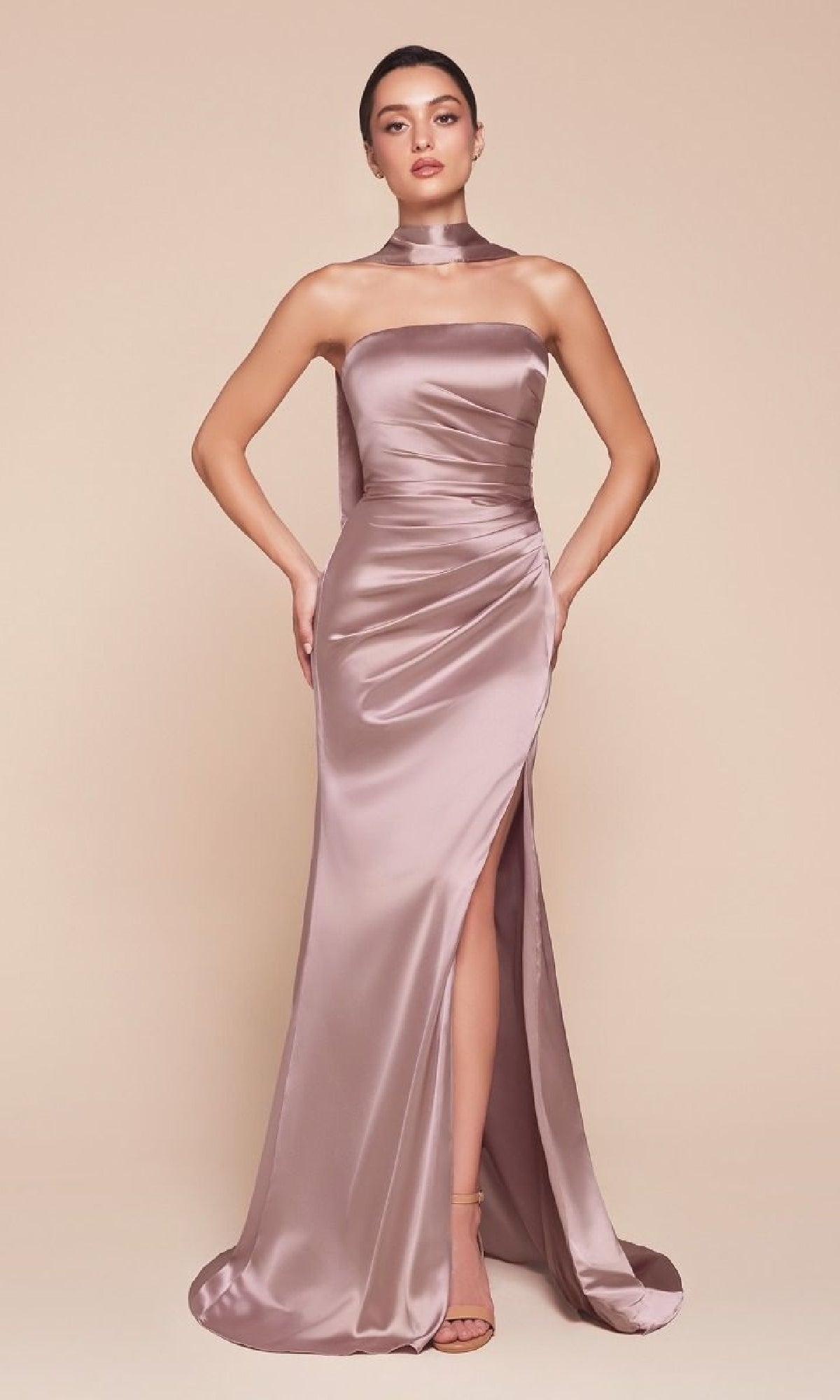 Model in the Simple Strapless Long Prom Dress: Ladivine 7451, a mauve satin gown with a high slit and matching neck scarf, styled with nude heels, poses against a beige background.