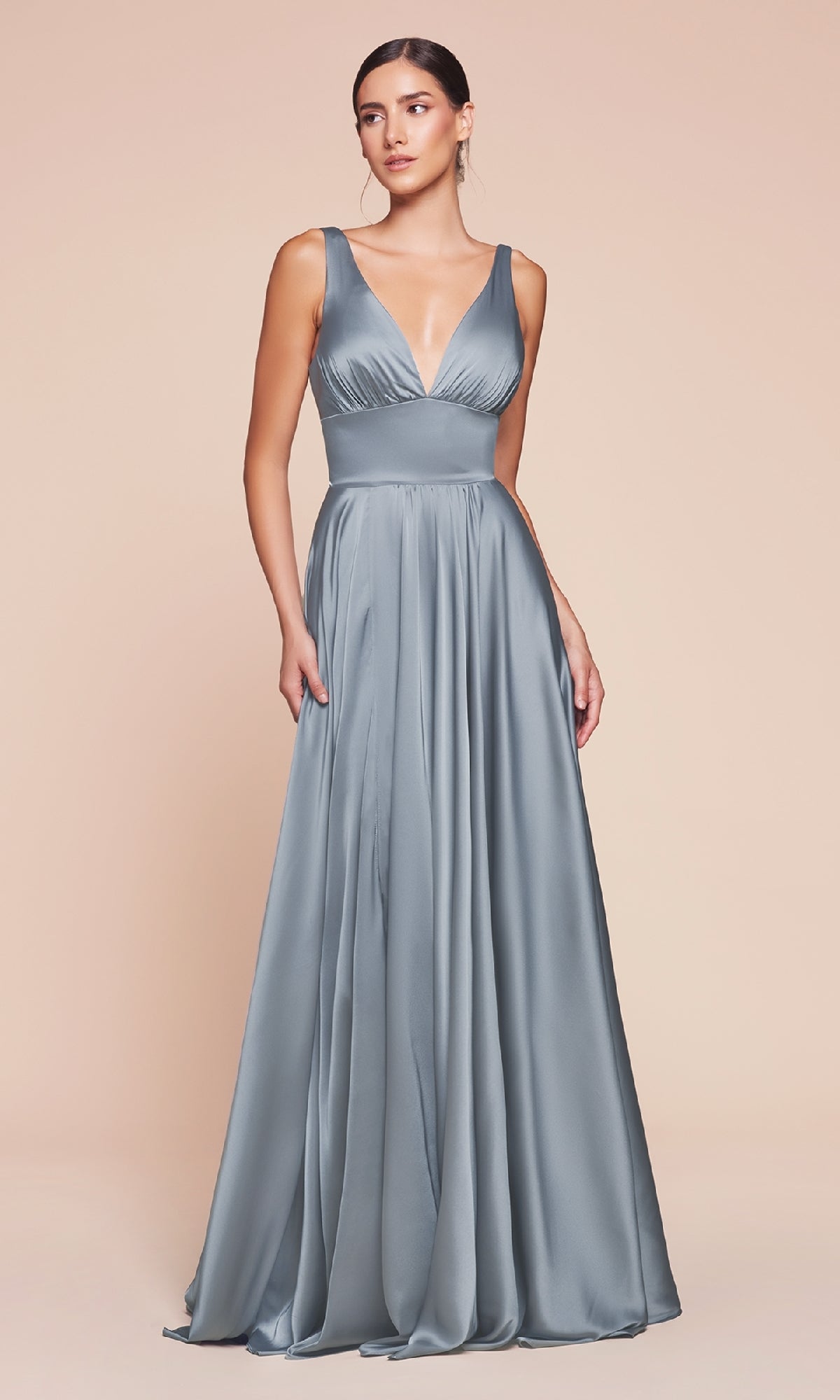 A woman models the A-Line V-Neck Classic Long Satin Prom Dress, featuring a floor-length, sleeveless design with a deep V-neckline, standing against a plain beige background.