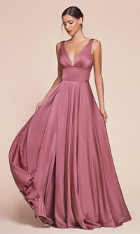 A woman in the Sleeveless Classic Long Prom Dress: Ladivine 7469—floor-length, mauve satin with a deep V-neckline—stands against a plain beige background.