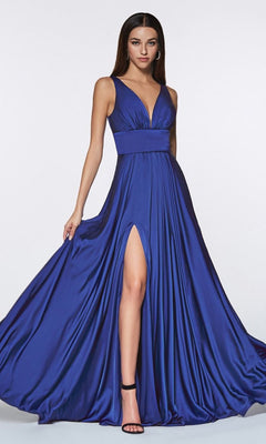 A woman poses against a plain background in the A-Line V-Neck Classic Long Satin Prom Dress, featuring a sleeveless deep blue design with a v-neckline, thigh-high slit, and paired with black high-heeled sandals.