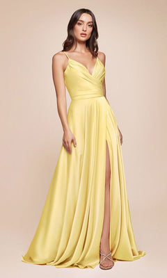 A woman models the Ladivine 7485 Classic Long Satin Formal Prom Dress, a sleeveless yellow gown with a wrap bodice and high slit, against a plain beige background.