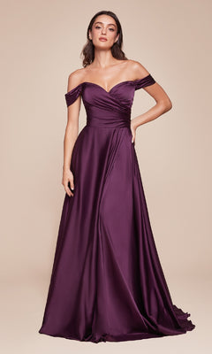 A woman models the Ladivine 7493-1 off-the-shoulder long prom dress in deep purple satin, standing against a plain beige background.