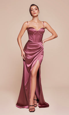 A woman stands against a beige background wearing the Ladivine 7495-1 long satin prom dress, featuring a fitted mauve design, lace-up back, thigh-high slit, and spaghetti straps.