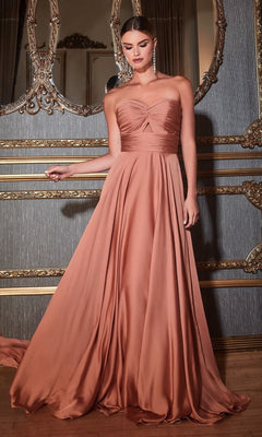 A woman wearing the Strapless Sweetheart Long A-Line Prom Dress 7496 stands in an ornately decorated room with gold-trimmed walls and a large mirror, highlighting the elegance of her floor-length peach formal gown.