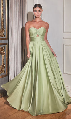 A woman stands indoors wearing the Strapless Sweetheart Long A-Line Prom Dress 7496—a floor-length, light green satin gown with a sweetheart neckline and small front cutout.