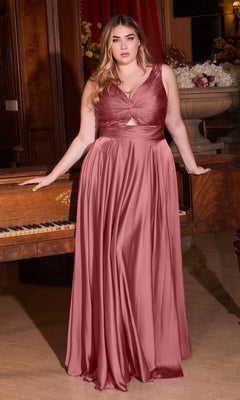 A woman poses by a piano in the Twist-Front Long Plus-Size Prom Dress 7497C, her sleeveless, floor-length rose-mauve gown radiating elegance in this stunning indoor setting—all at an affordable price.