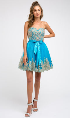A woman models the Juliet 759 Short Hoco Dress, featuring a blue strapless A-line skirt with gold embroidery and a satin ribbon, paired with high-heeled sandals against a plain background.