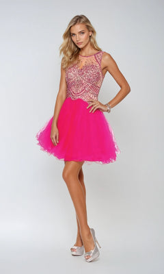 A woman poses in the Juliet 761 short party dress—a hot pink, sleeveless mini dress with a beaded bodice, sheer neckline, and A-line tulle skirt—paired with silver high heels against a light background. Perfect for homecoming!.