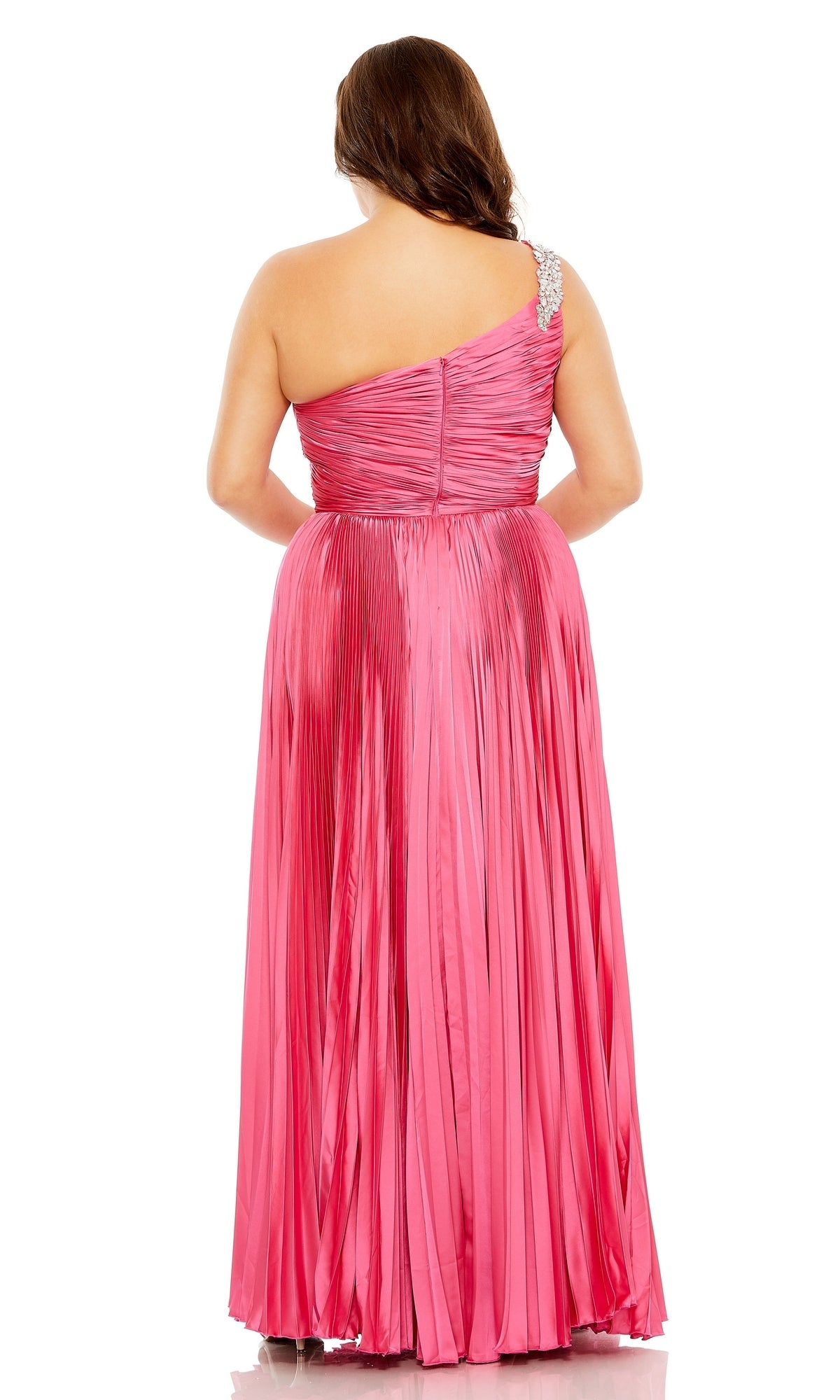 A woman faces away, wearing the Long Plus-Size Formal Dress 77005 by Mac Duggal—a pink pleated one-shoulder gown with a jeweled strap and floor-length skirt.