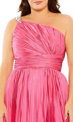 A person wears the Long Plus-Size Formal Dress 77005 by Mac Duggal—a shiny, pleated pink one-shoulder dress with a decorative embellished strap—shown from shoulders to waist.