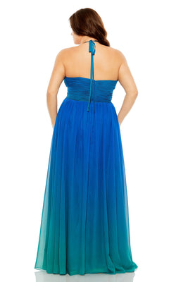 A woman wears the Long Plus-Size Formal Dress 77017 by Mac Duggal, a strapless, floor-length blue ombré A-line gown with a back tie detail and flowing skirt, as she stands facing away.