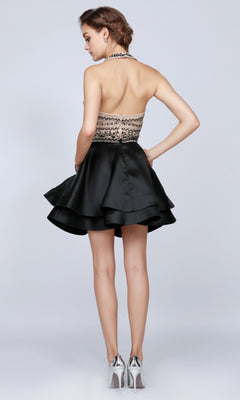 A woman stands with her back to the camera, wearing the Short Party Dress: Juliet 777—featuring a black halter neckline, layered skirt, and paired with silver high heels.