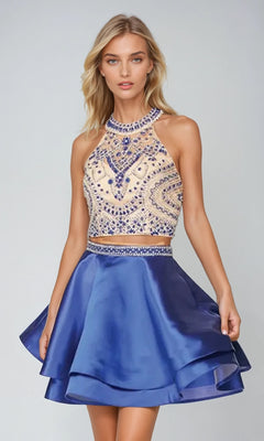 A woman models the Juliet 777 short party dress, featuring a sleeveless beaded top with intricate patterns and a shiny royal blue flared skirt, posing elegantly against a plain background.
