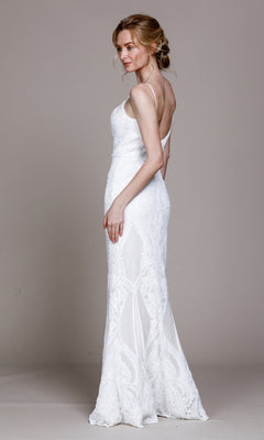 A woman stands in profile wearing the Sequin-Print Sleek Long Prom Dress 791, a fitted, floor-length gown with thin straps and a deep v-back, against a plain background.
