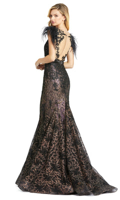 A woman wearing the Mac Duggal 79230 Feathered Long Lace Formal Dress, featuring black lace, feathered shoulders, a low back, and a floor-length flared skirt.