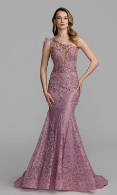 A woman stands wearing a fitted, floor-length rose gown—the Feather One-Shoulder Prom Gown: Mac Duggal 79264—adorned with elegant floral embellishments and featuring an eye-catching sheer panel at the neckline, set against a plain gray background.