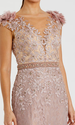 Woman wearing the Cap-Sleeve Long Formal Dress Mac Duggal 79368 in blush pink, featuring floral lace embroidery, a sheer bodice, beaded waistline, and 3D floral appliqués on the shoulders.