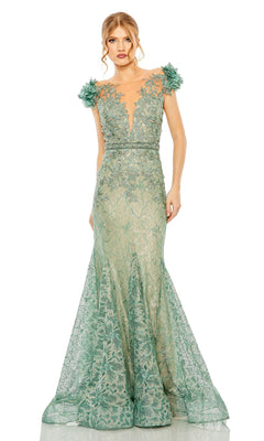 A woman in the Mac Duggal 79368 cap-sleeve long formal dress, featuring light green fabric, floral appliqués on the shoulders, and a deep V-neckline, stands against a plain white background.
