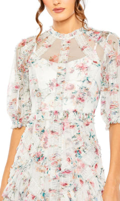 A woman in the Mac Duggal 80111 Short Sleeve Wedding Guest Dress—a white sheer floral tea-length dress with ruffles, puff sleeves, and a high neckline—perfect for parties or any special occasion.