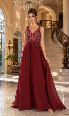 A woman stands indoors by a staircase wearing the Sleeveless V-Neck Chiffon Long Prom Dress 8012 in burgundy, featuring a lace bodice and flowing a-line skirt.