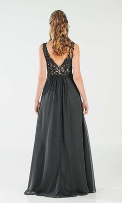 A woman with wavy hair faces away, wearing the Sleeveless V-Neck Chiffon Long Prom Dress 8012, featuring an elegant open back, lace bodice, and a flowing skirt.