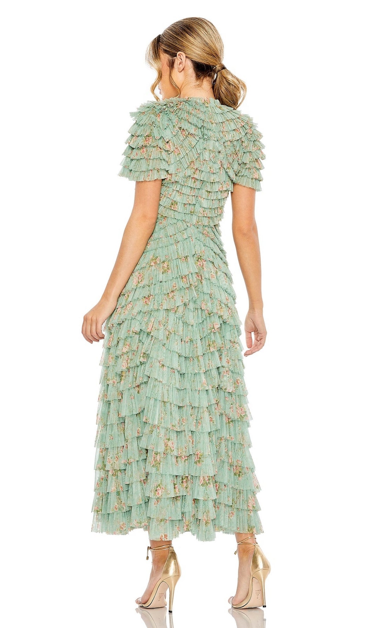 A woman faces away in the Midi Wedding Guest Dress 8014 by Mac Duggal, a sage green floral ruffle midi dress with short sleeves, paired with metallic high-heeled sandals for a graceful, semi-formal look.