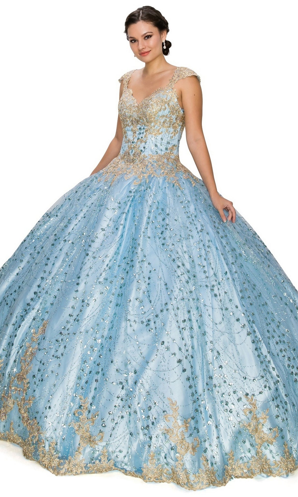 A woman poses against a white background wearing the Quinceanera Ball Gown 8024J, a light blue dress featuring gold lace embroidery and sequin details.